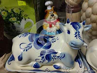 Souvenir ceramic cow butter dish on the shelf Stock Photo