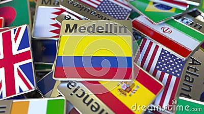 Souvenir magnet or badge with Medellin text and national flag among different ones. Traveling to Colombia conceptual 3D Stock Photo