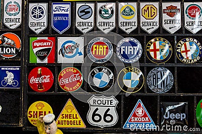 Souvenir magnets with logos of famous automotive brands, oil companies and beverage producers. Editorial Stock Photo