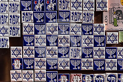 Souvenir shop display with colorful fridge magnet tiles with Jewish symbols, Toledo, Spain. Editorial Stock Photo