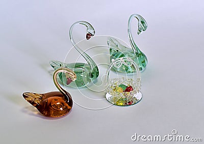 Souvenir swans made of glass with colorful eggs made of glass Stock Photo