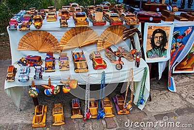 Souvenirs from Cuba. Wooden toys: retro machines, fan, boxes, figurines. Painting and camera from a tin can Editorial Stock Photo
