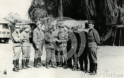 Soviet airborne officers considering the shoes - the shoes of the Czechoslovak troops. Prague. August 1968 Editorial Stock Photo