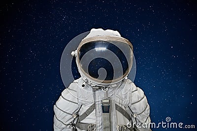 Soviet cosmonaut or astronaut or spaceman suit and helmet on black space with stars background Stock Photo