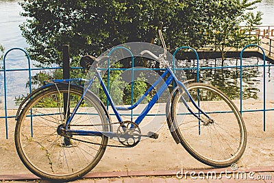 Soviet land bike. The simplest transport manual control in vintage style and warm colors. Stock Photo