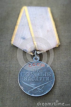 Soviet Medal for Combat Service and two red carnations. Stock Photo