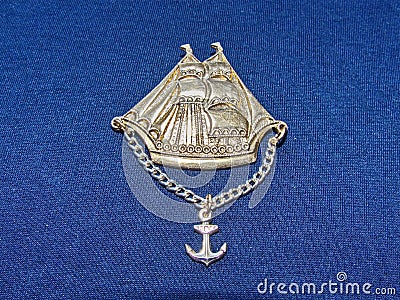 Soviet metal badge of a Caravel with a chain and anchor from the series `sailboats of the world`. Faleristics. Stock Photo