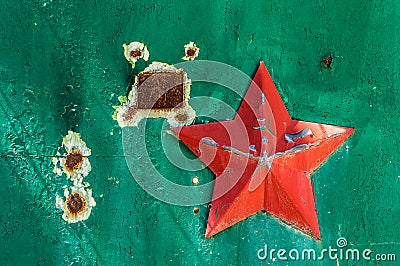 Soviet military five-pointed star on the green scuffed gate Stock Photo