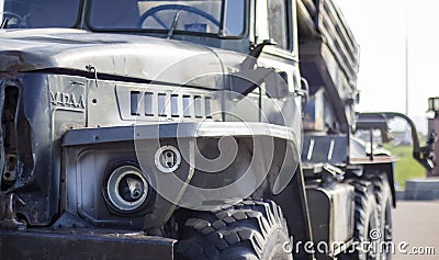 Soviet multiple launch rocket system BM-21 Grad on the chassis of a truck Ural-375D. Broken and burnt military equipment of the Editorial Stock Photo