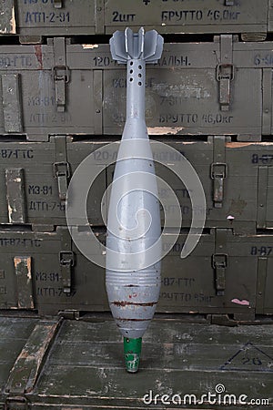 Soviet or russian 120 mm mortar shell on army green crate. Text in russian - type of ammunition, projectile caliber, projectile Editorial Stock Photo