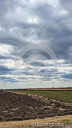Sowing time in Ukraine during the war. Preparing fields for sowing grain. Blue sky, plowed land. terror. Stock Photo