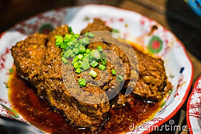 Soy Bean Sauce Pork Ribs with chopped shallots in a porcelain dish Stock Photo