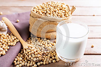 Soy milk in a glass with soybeans on a wooden table Organic breakfast, high protein, healthy, agricultural products, vegetarian Stock Photo