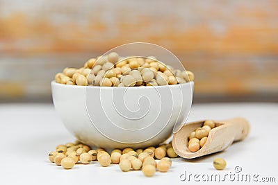 Soybean on bolw and wood background - dry soy beans Stock Photo
