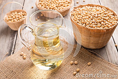 Soybean and soybean oil in jar on wood Stock Photo