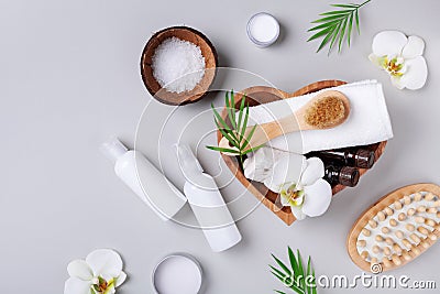 Spa, aromatherapy, beauty treatment and wellness background with massage brush, orchid flowers and cosmetic products. Flat lay Stock Photo