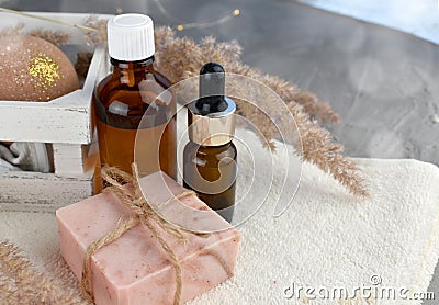 Spa aromatherapy set with essential oil bottle, soap bar on towel. Wellness still life composition. Stock Photo