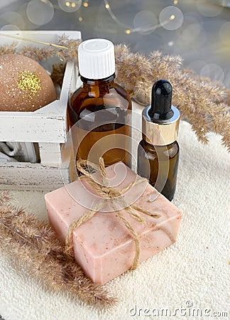 Spa bath set with essential oil bottle, soap bar on towel. Wellness still life composition. Stock Photo