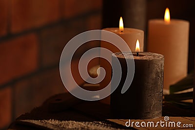 Spa composition with burning candles on massage table in wellness canter, space for text Stock Photo