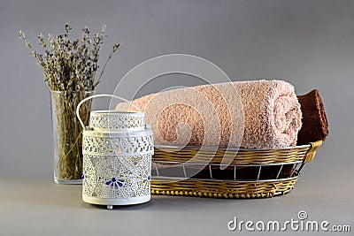 Spa composition on gray background: towels, aroma candle and dry bouquet of lavender Stock Photo