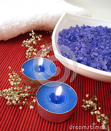 Spa essentials (blue salt, towels, candle and flower) Stock Photo