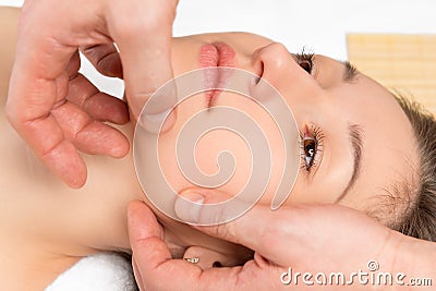 Spa facial massage hands cosmetologist man Stock Photo