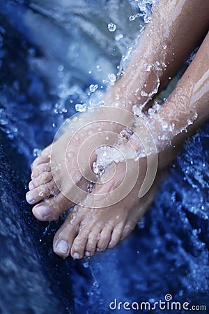 Spa - Female leg massage with aerated blue water Stock Photo