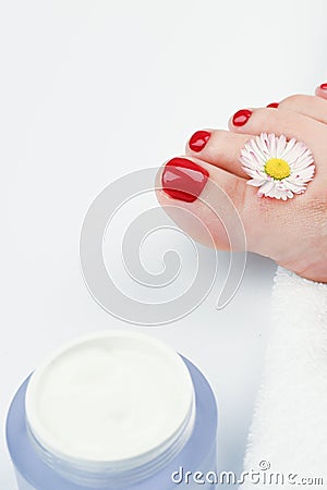 Spa and foot care concept. Women`s legs with a white rolled towel Stock Photo