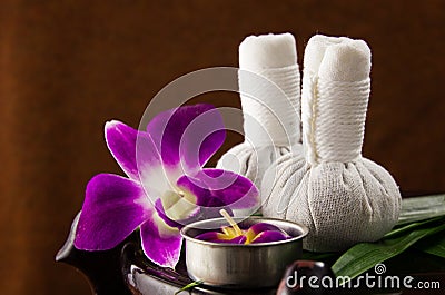 Spa herbal compressing ball with candles and orchid Stock Photo