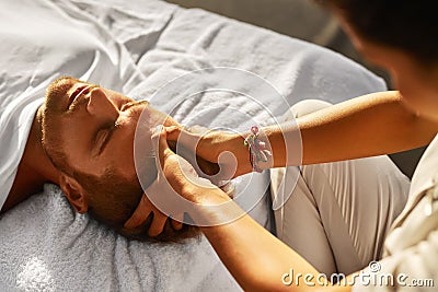 Spa Massage. Man Enjoying Relaxing Head Massage Outdoors. Beauty Stock Photo