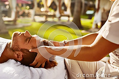 Spa Massage. Man Enjoying Relaxing Head Massage Outdoors. Beauty Stock Photo