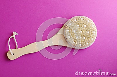 Spa massage wooden body brush on purple background Stock Photo