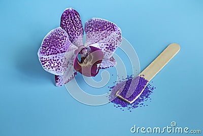 Spa mockup: purple cosmetic spa with sea fiolet salt and purple orchid on blue background. Stock Photo