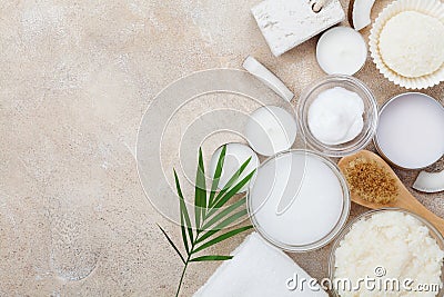 Spa setting from body care, wellness and beauty treatment. Organic coconut scrub, oil and cream on stone table top view. Flat lay. Stock Photo