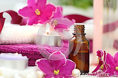 SPA setting with candles, aroma oil and violets Stock Photo