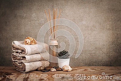 Spa essentials, aroma sticks, stones, towels, sea shell on a wooden rustic background Stock Photo
