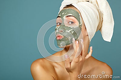 Spa teen girl applying facial clay mask. Beauty treatments. Stock Photo