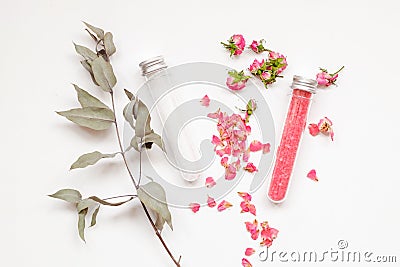 Spa or wellness. Pink salt with a rose and white sea salt in cones on a light background. Rose petals and dried buds Stock Photo