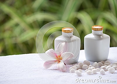 Spa and wellness setting with natural soap, stones and towel on the green background . Stock Photo
