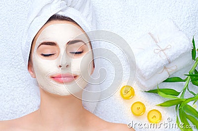 Spa woman applying facial mask Stock Photo