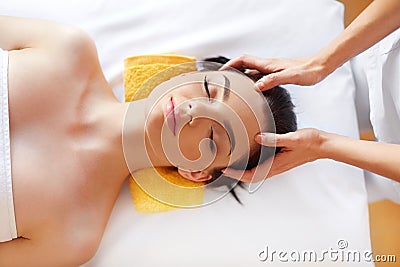 Spa Woman. Beautiful Young Woman Getting a Face Treatment at Beauty Salon. Face Massage Stock Photo