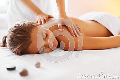 Spa woman. Female enjoying massage in spa centre. Stock Photo