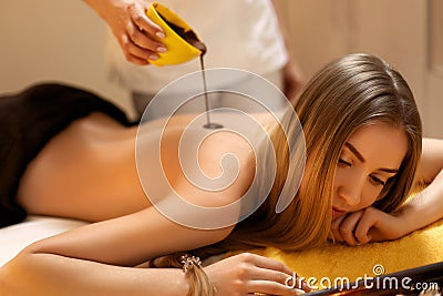 Spa Woman. Young Woman Gets Chocolate Body Mask at Beauty Salon Stock Photo