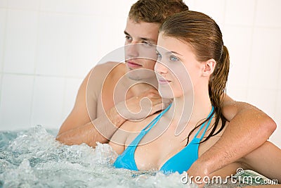 Spa - young loving couple enjoy hot tub Stock Photo