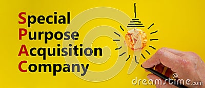 SPAC, special purpose acquisition company symbol. Word `SPAC` on beautiful yellow background, copy space. Businessman hand, ligh Stock Photo