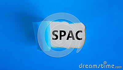 SPAC, special purpose acquisition company symbol. Words `SPAC` appearing behind torn blue paper. Beautiful blue background, copy Stock Photo