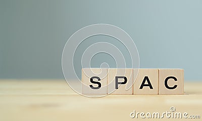 SPAC symbol. Wooden cubes with words SPAC, special purpose acquisition companies` on beautiful grey background, copy space. Inves Stock Photo