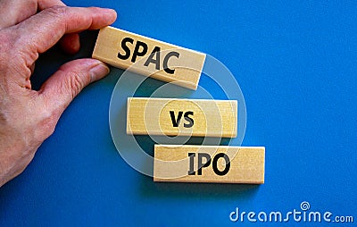 SPAC vs IPO symbol. Blocks with words `SPAC, special purpose acquisition company` and `IPO, initial public offering` on blue Stock Photo