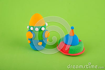 Space figures made of polymer clay, modelling dough on green background Stock Photo
