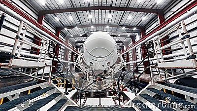 Space launch preparation. Spaceship SpaceX Crew Dragon, atop the Falcon 9 rocket, inside the hangar , just before Editorial Stock Photo